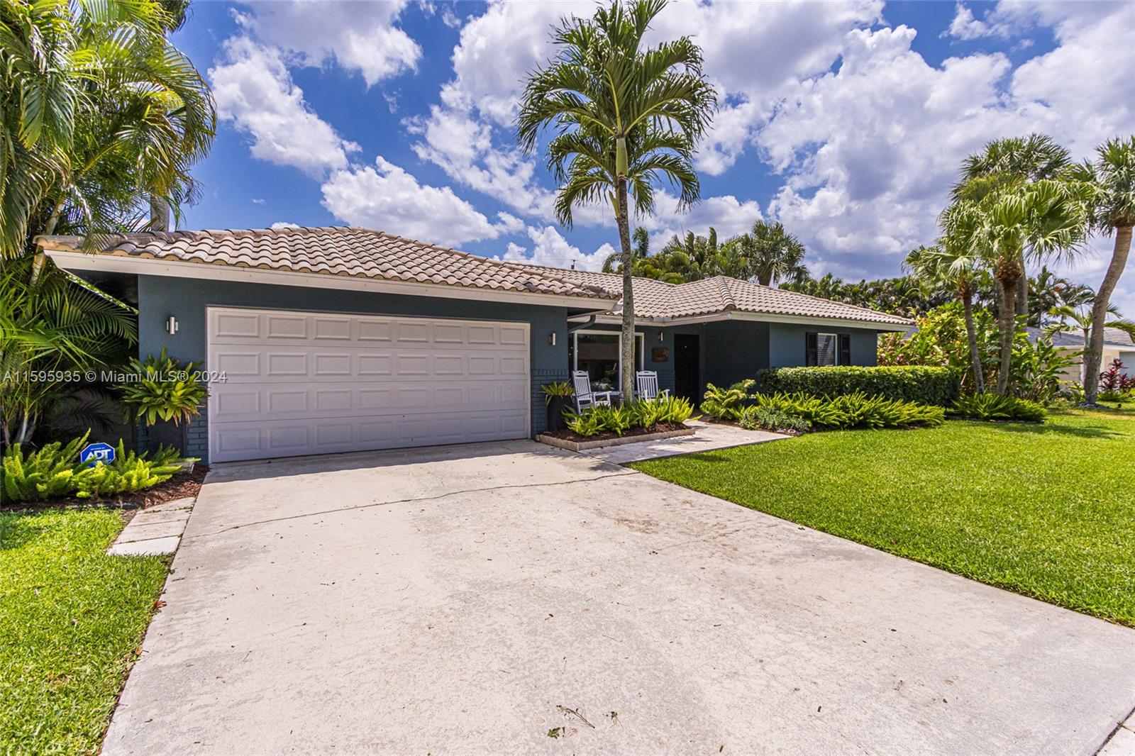 20 Burning Tree Lane Boca Raton, FL 33431 - Photo 2 of 64 a front view of a house with a yard and garage
