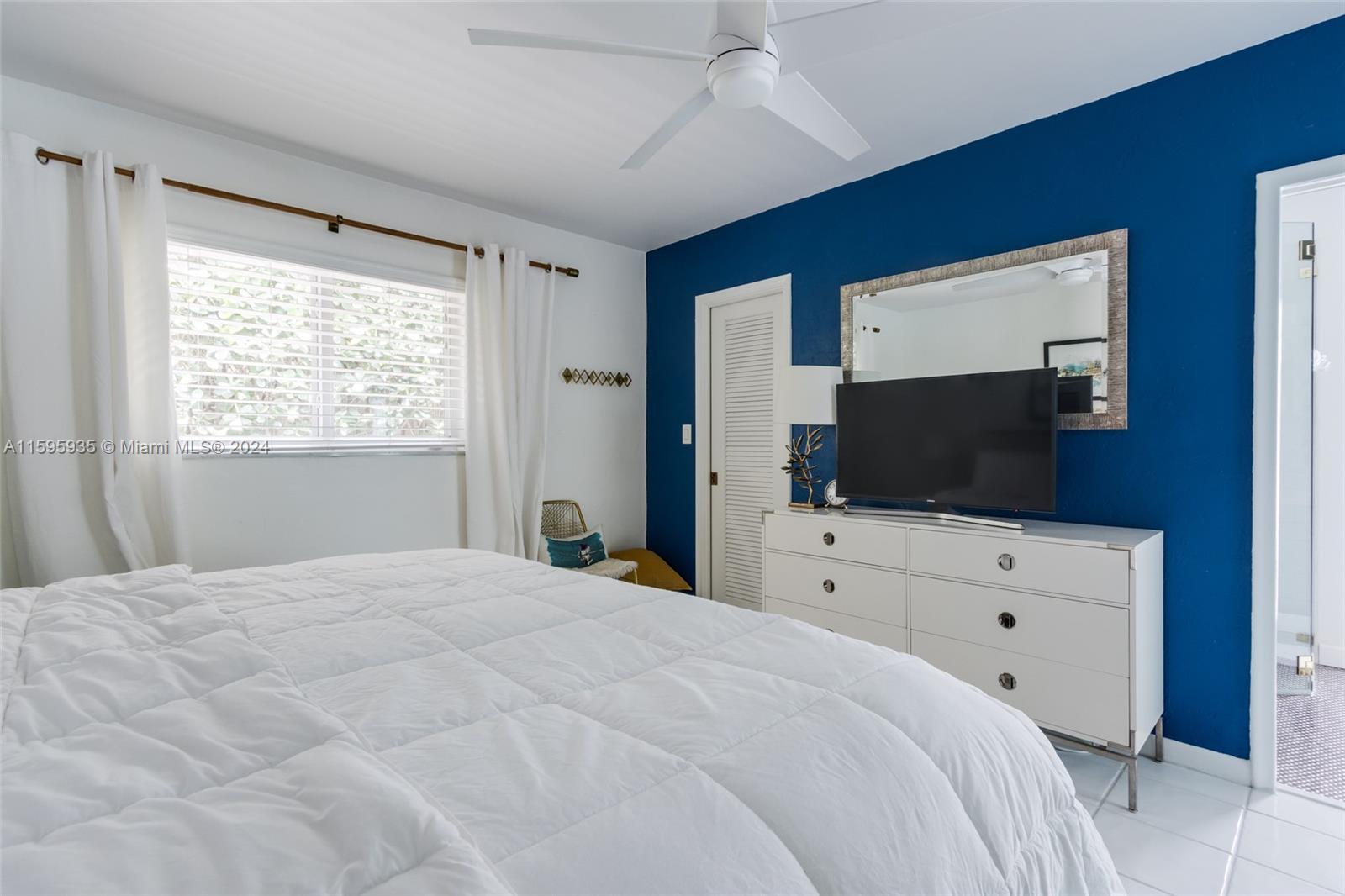 20 Burning Tree Lane Boca Raton, FL 33431 - Photo 29 of 64 a bedroom with a large bed and a flat screen tv