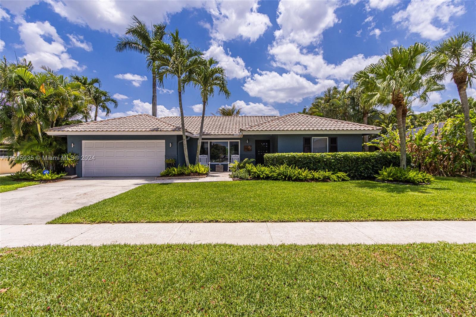 20 Burning Tree Lane Boca Raton, FL 33431 - Photo 3 of 64 a front view of a house with a garden and yard
