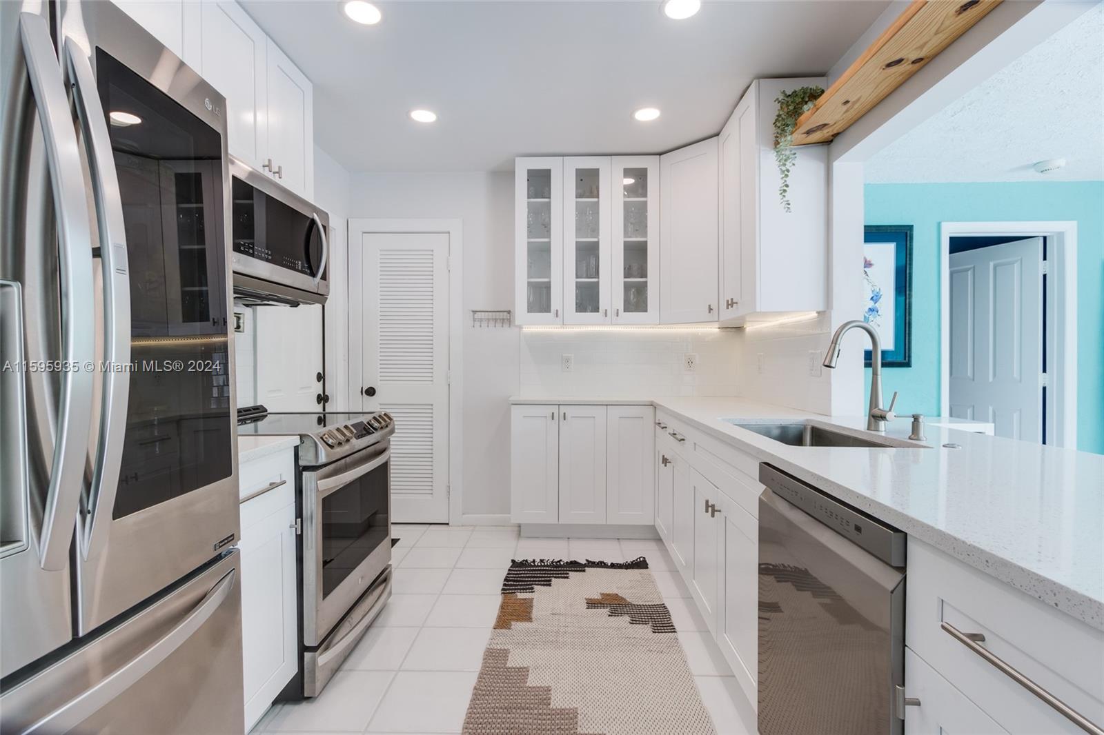 20 Burning Tree Lane Boca Raton, FL 33431 - Photo 34 of 64 a kitchen with stainless steel appliances granite countertop a refrigerator and a stove