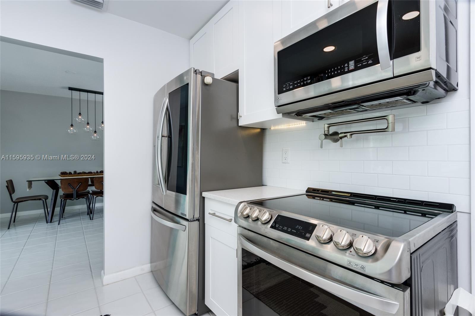 20 Burning Tree Lane Boca Raton, FL 33431 - Photo 36 of 64 a kitchen with a stove and a refrigerator