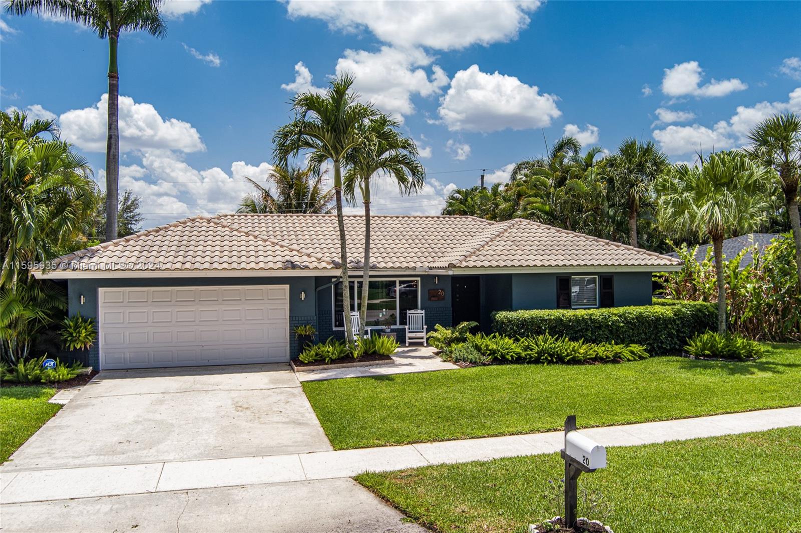 20 Burning Tree Lane Boca Raton, FL 33431 - Photo 44 of 64 a front view of a house with a yard and potted plants