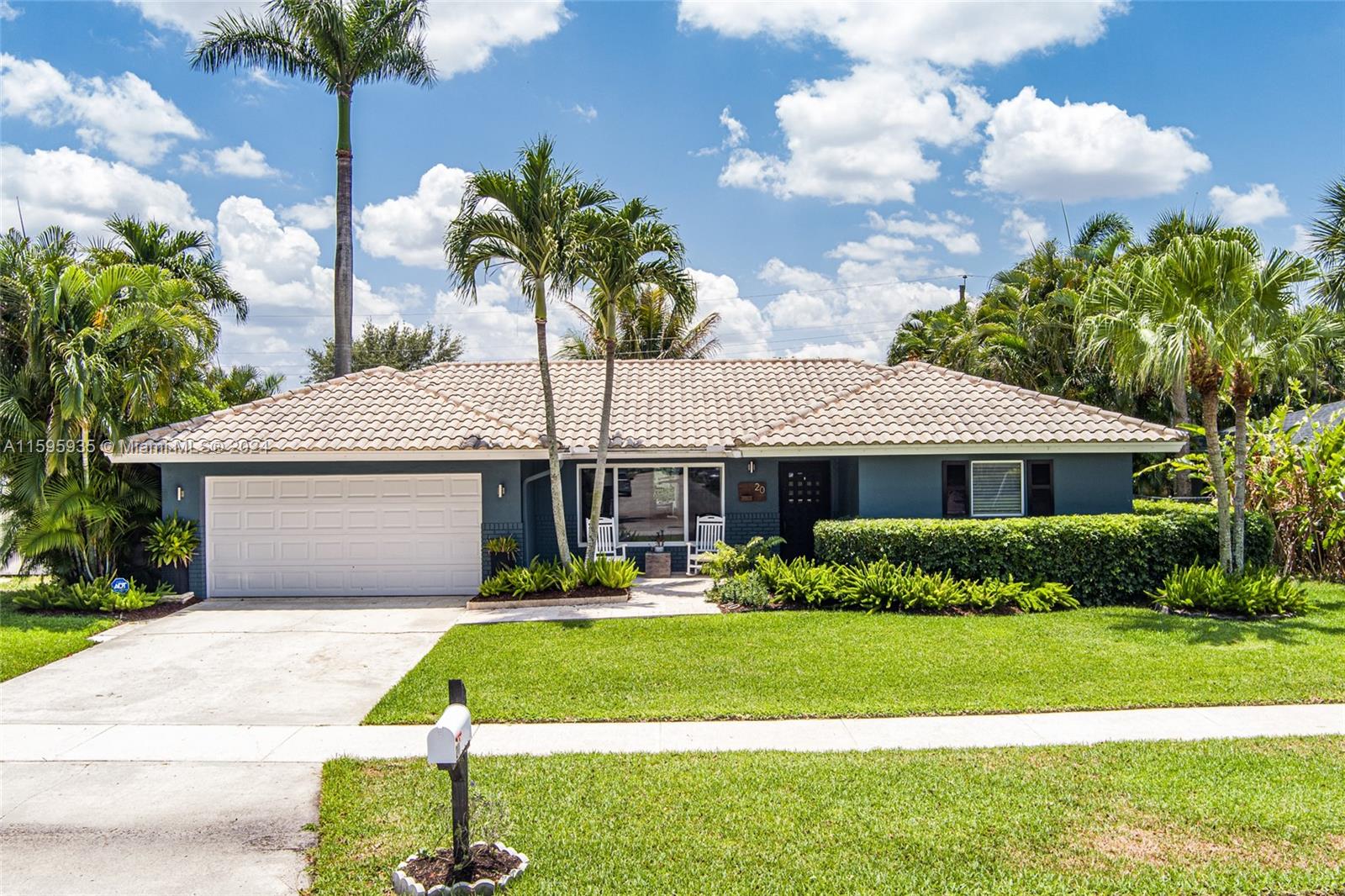20 Burning Tree Lane Boca Raton, FL 33431 - Photo 45 of 64 a front view of a house with a yard and potted plants