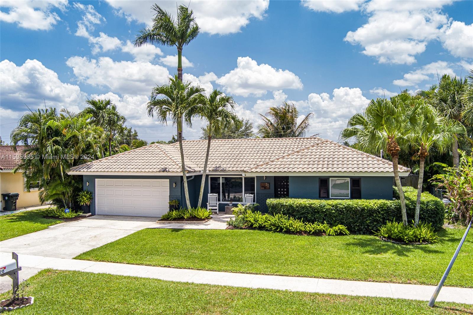 20 Burning Tree Lane Boca Raton, FL 33431 - Photo 46 of 64 a front view of a house with a garden and trees