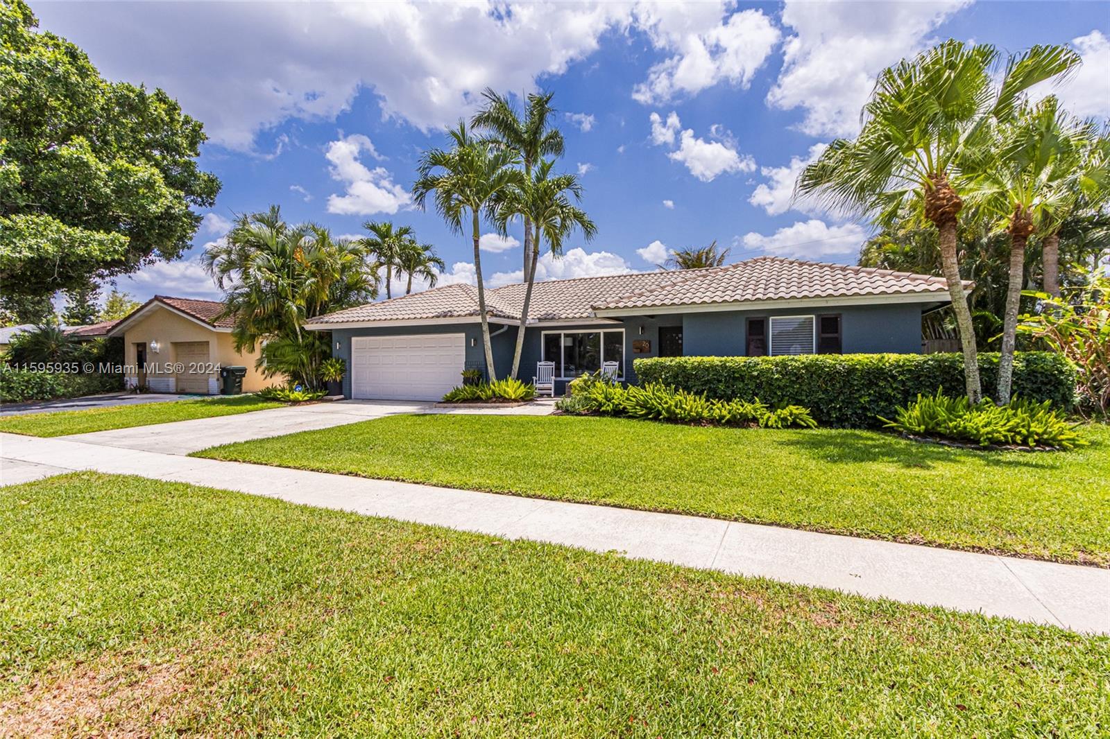 20 Burning Tree Lane Boca Raton, FL 33431 - Photo 5 of 64 a front view of a house with a garden and yard
