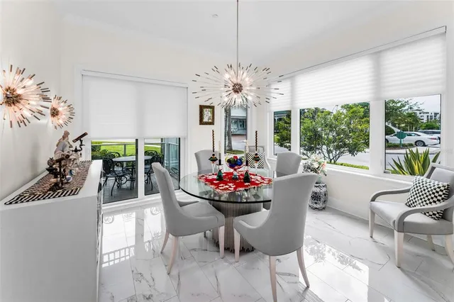 a living room with furniture a fireplace and a large window