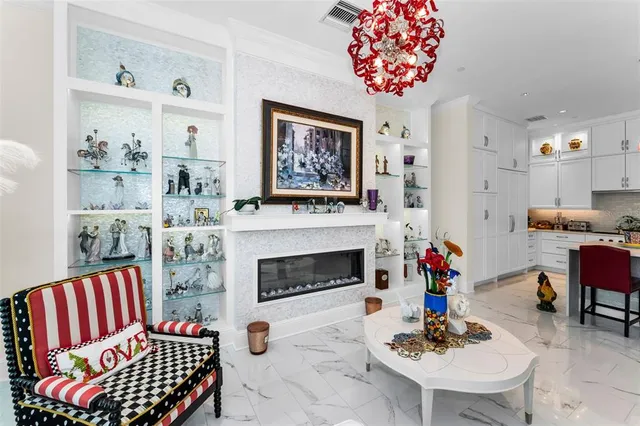 a living room with furniture a dining table and chairs with wooden floor