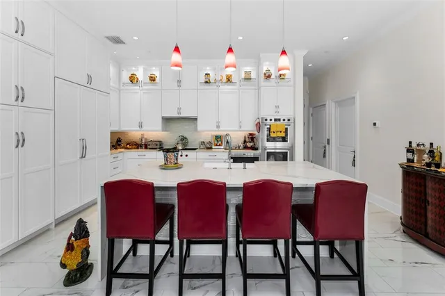 a bathroom with a granite countertop sink a toilet and a window