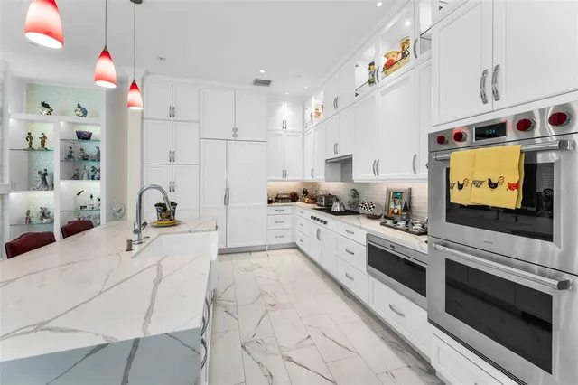 a bedroom with furniture a flat screen tv and a large window