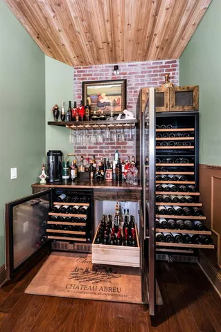 a front view of a house with a yard and potted plants