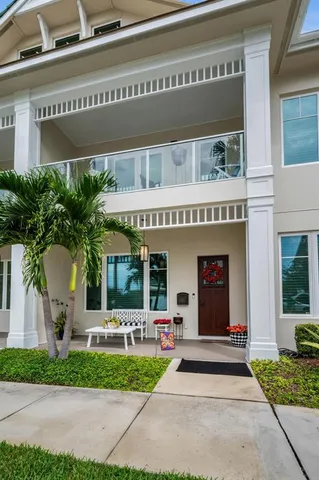a dining room with furniture and a potted plant