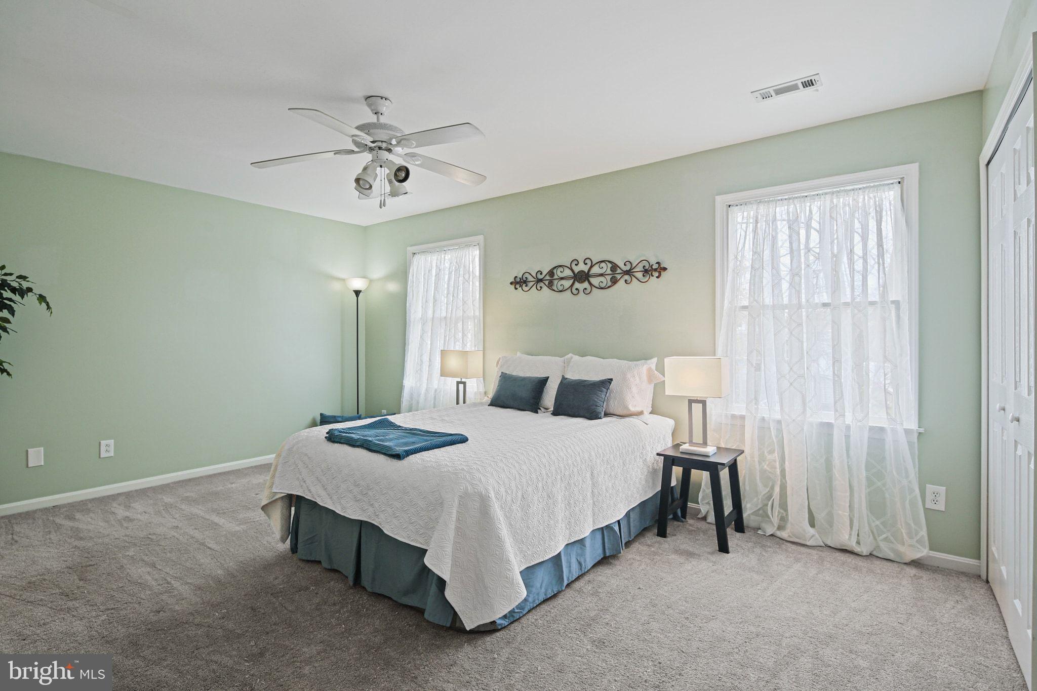 1617 Midland Road Edgewater, MD 21037 - Photo 16 of 41 a bedroom with a bed and a chandelier