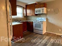 804 3rd Avenue Southwest Conover, NC 28613 - Photo 2 of 8 a kitchen with a stove and a sink
