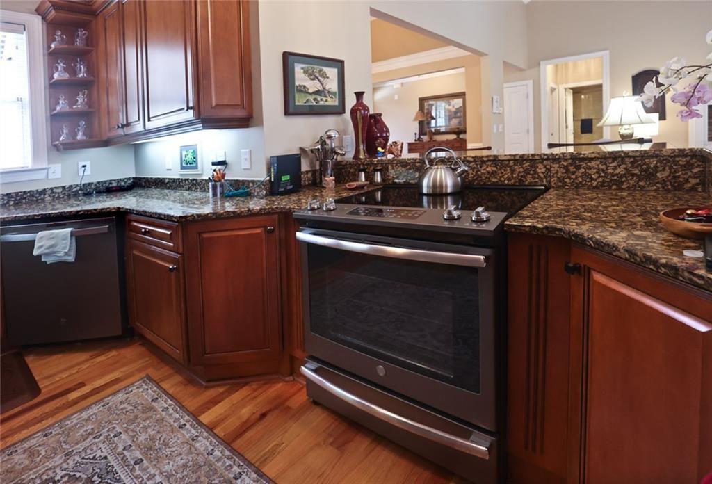 42 Crooked Branch Road Clayton, GA 30525 - Photo 12 of 48 a kitchen with stainless steel appliances granite countertop a stove a sink and a microwave
