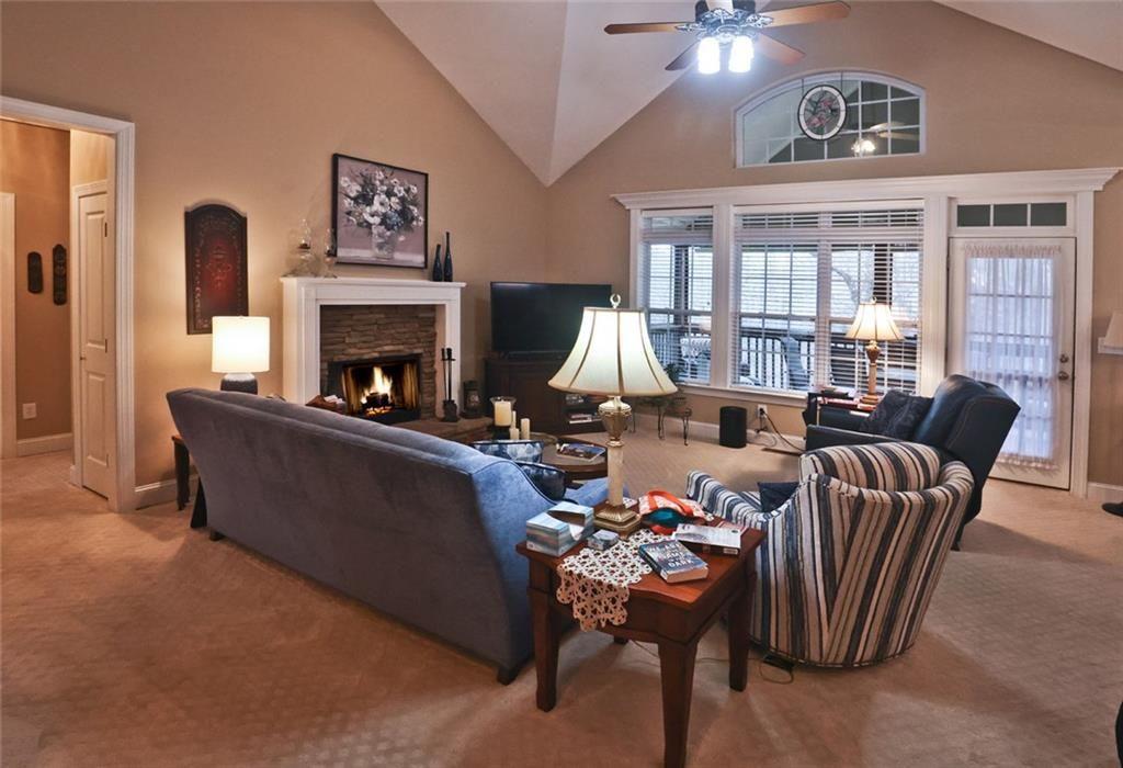 42 Crooked Branch Road Clayton, GA 30525 - Photo 16 of 48 a living room with furniture a chandelier and a fireplace