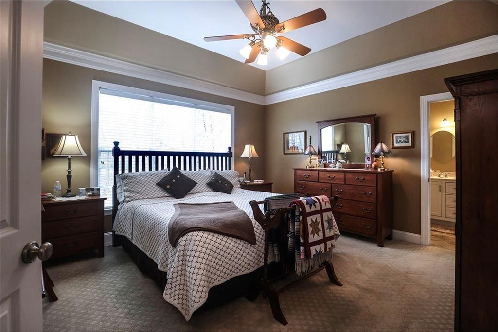 42 Crooked Branch Road Clayton, GA 30525 - Photo 17 of 48 a bedroom with a bed and a chandelier