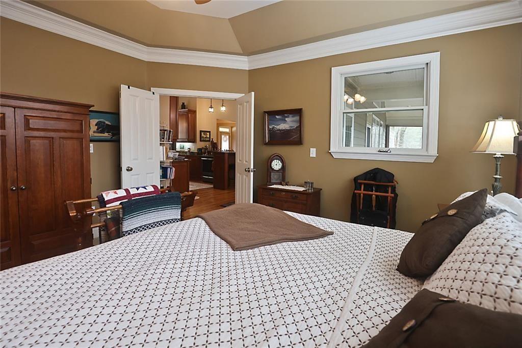 42 Crooked Branch Road Clayton, GA 30525 - Photo 18 of 48 a bedroom with a bed and a lamp on dresser