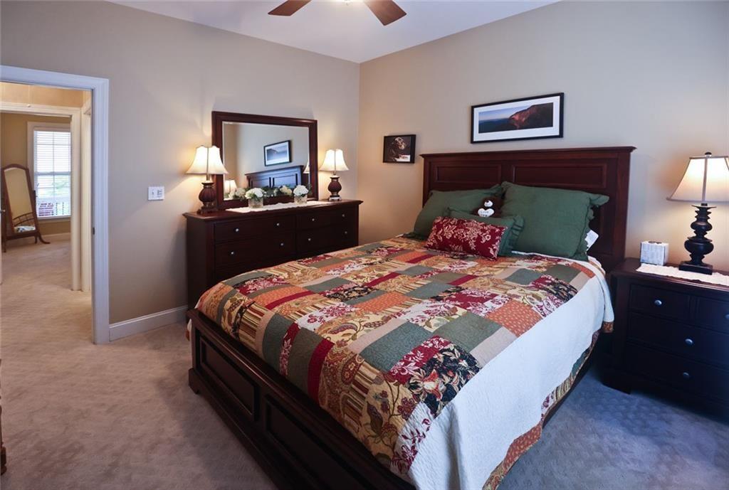 42 Crooked Branch Road Clayton, GA 30525 - Photo 24 of 48 a bed sitting in a bedroom and a lamp