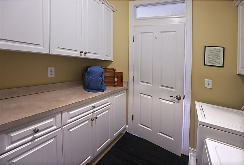 42 Crooked Branch Road Clayton, GA 30525 - Photo 30 of 48 a kitchen with a refrigerator and white cabinets