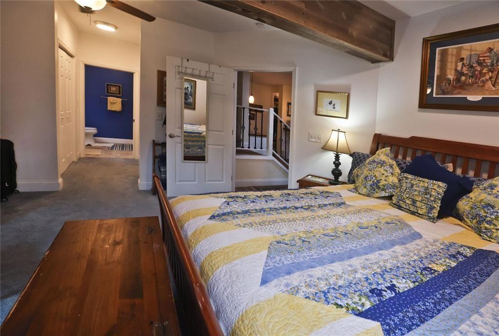 42 Crooked Branch Road Clayton, GA 30525 - Photo 41 of 48 a spacious bedroom with a bed and wooden floor