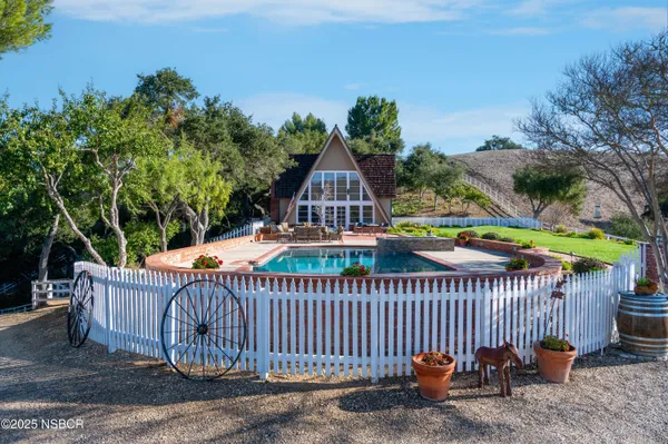 a view of a roof deck with wooden fence and trees