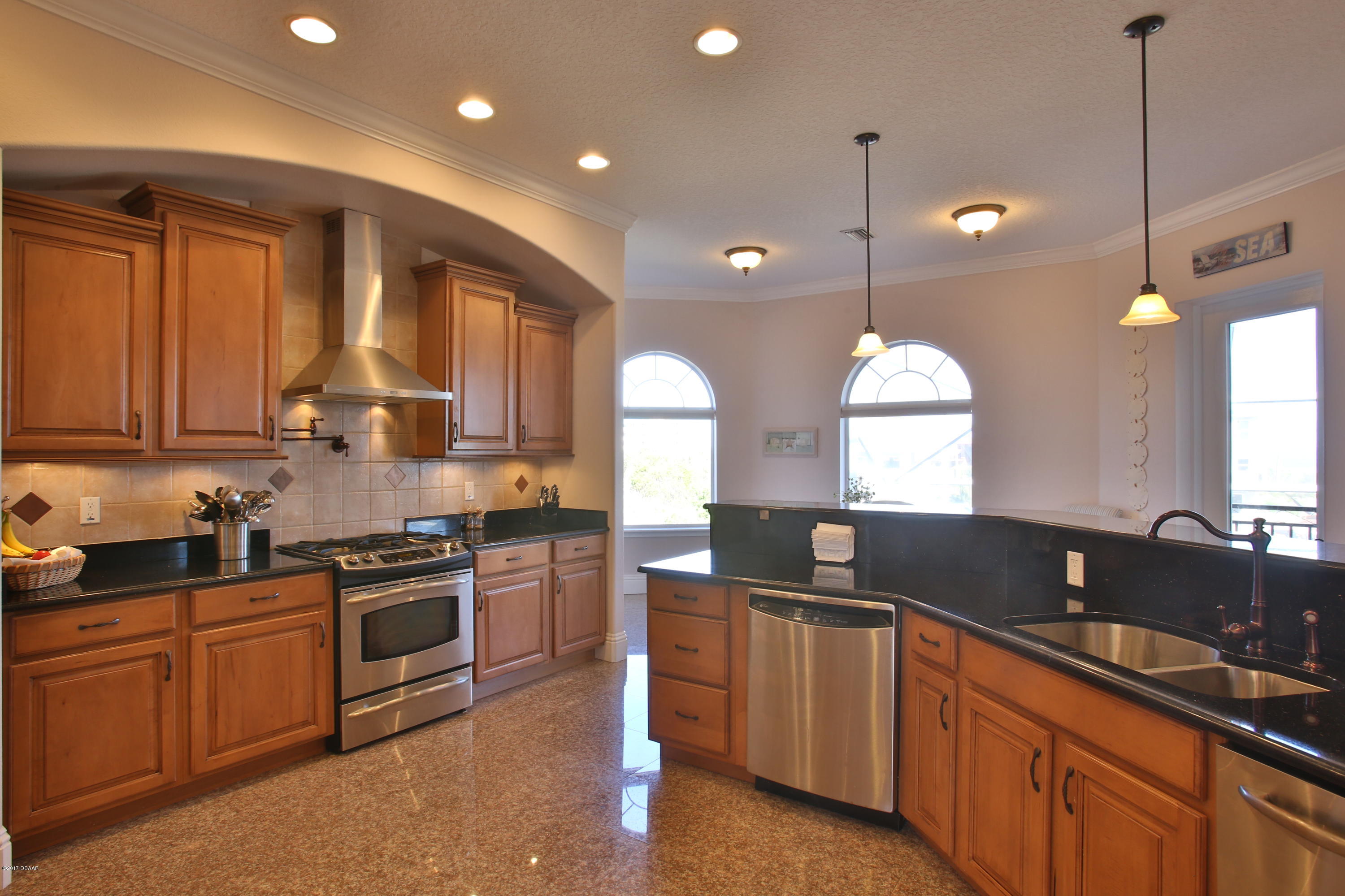 3 Mar Azul South Ponce Inlet, FL 32127 - Photo 11 of 36 a kitchen with granite countertop a sink a stove and cabinets