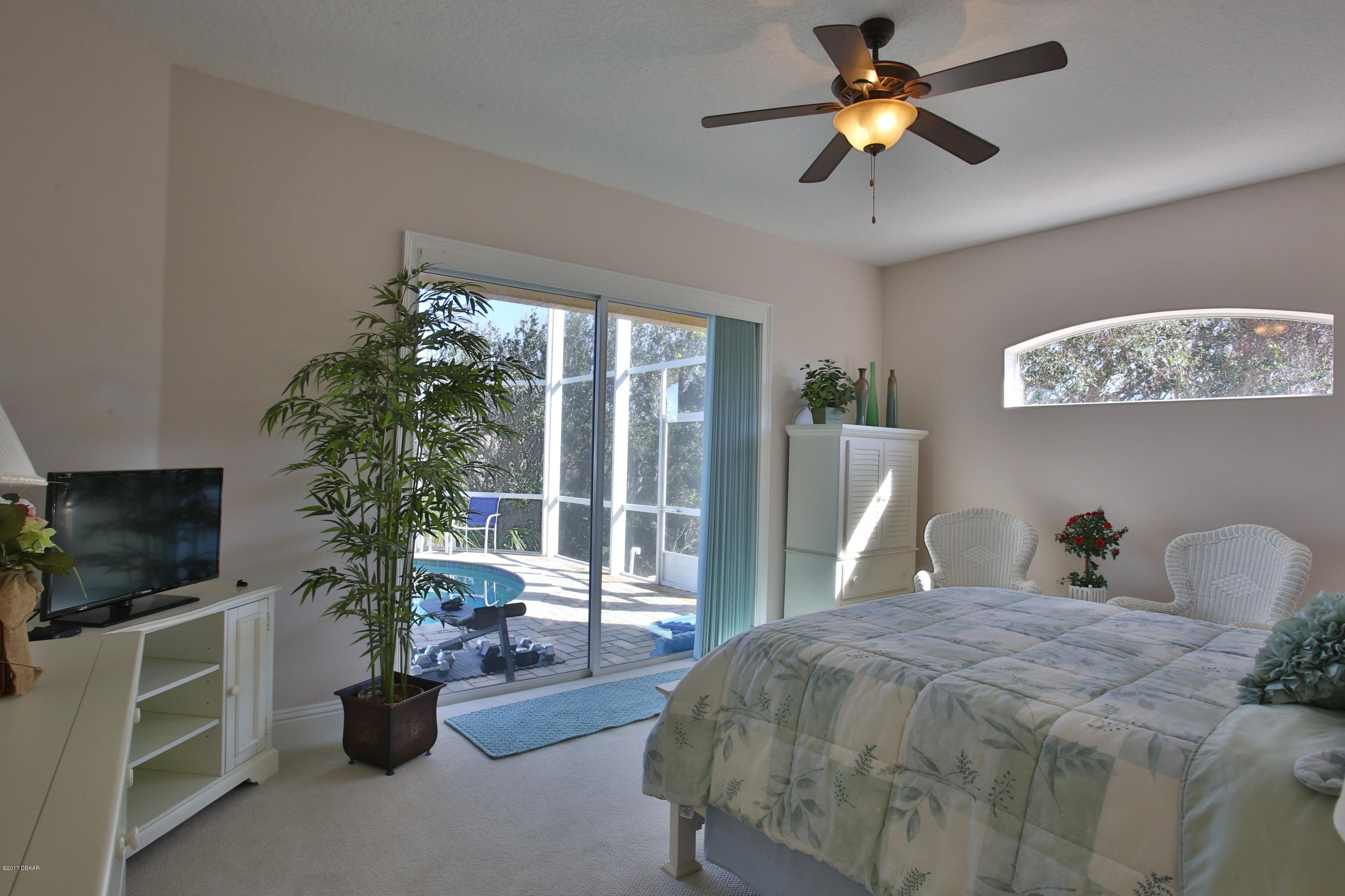 3 Mar Azul South Ponce Inlet, FL 32127 - Photo 26 of 36 a bedroom with a bed and a chandelier
