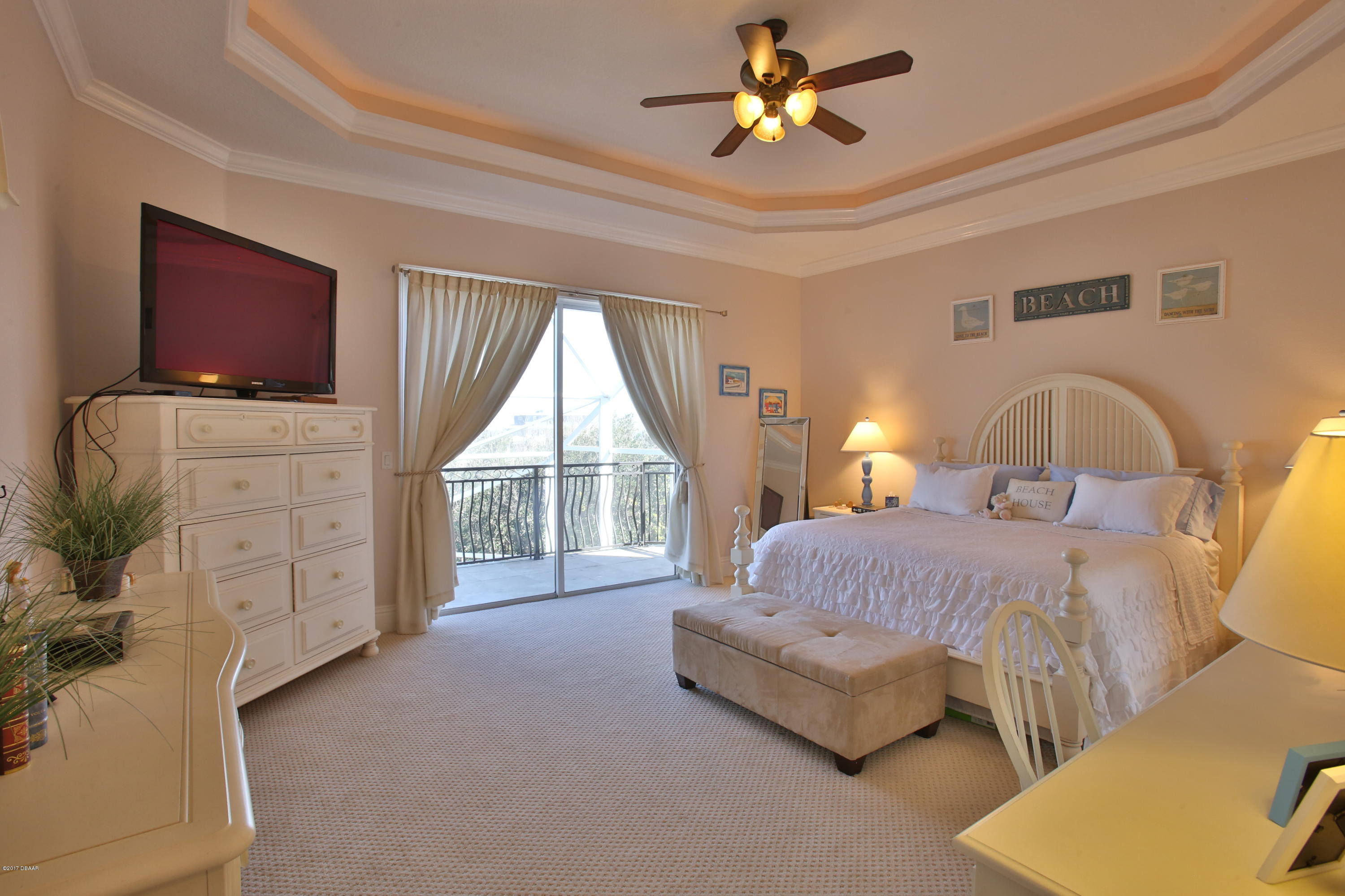 3 Mar Azul South Ponce Inlet, FL 32127 - Photo 6 of 36 a spacious bedroom with a bed a couch and a chandelier