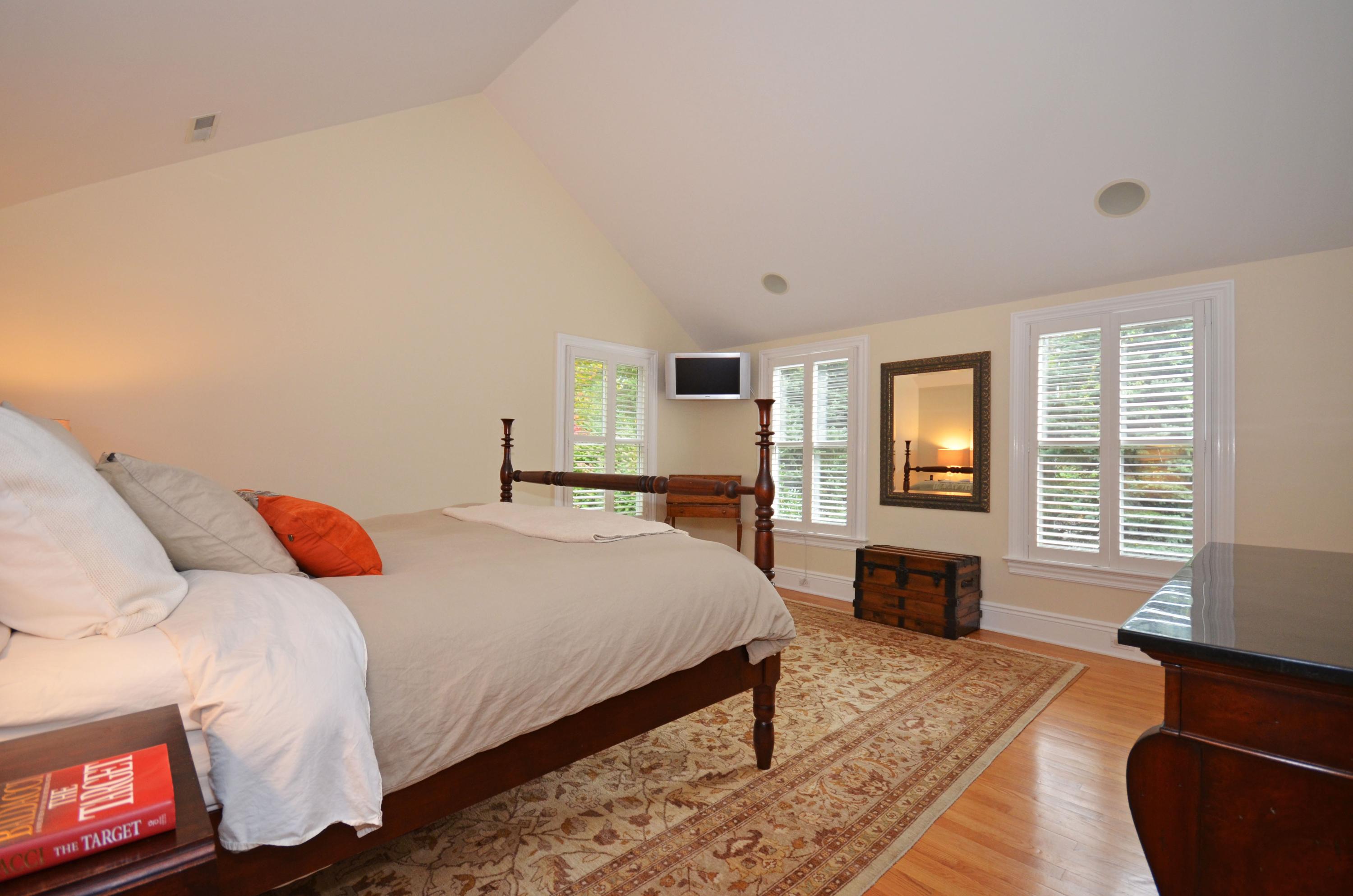 45 Brookside Road Darien, CT 06820 - Photo 12 of 24 a bedroom with a bed and wooden floor
