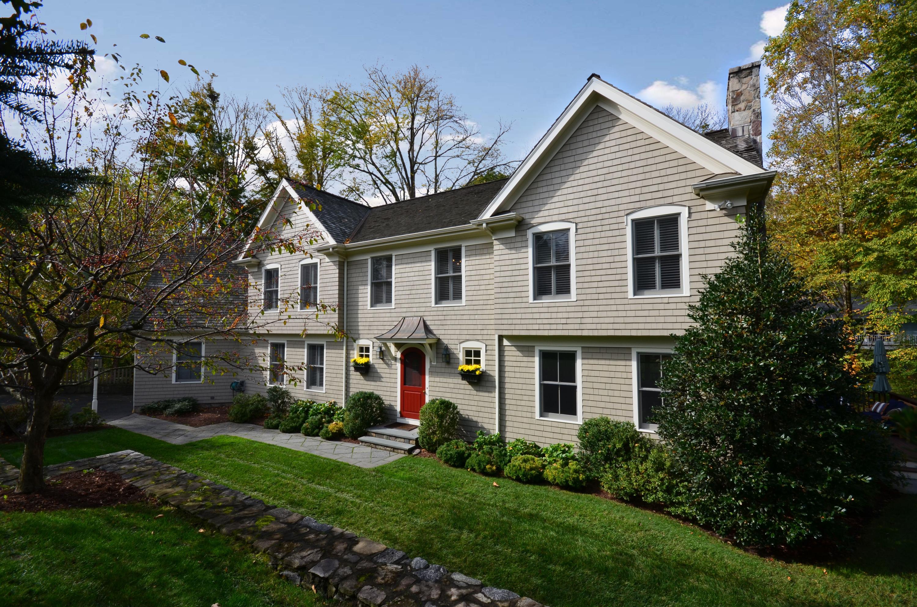 45 Brookside Road Darien, CT 06820 - Photo 2 of 24 a front view of a house with a garden and plants