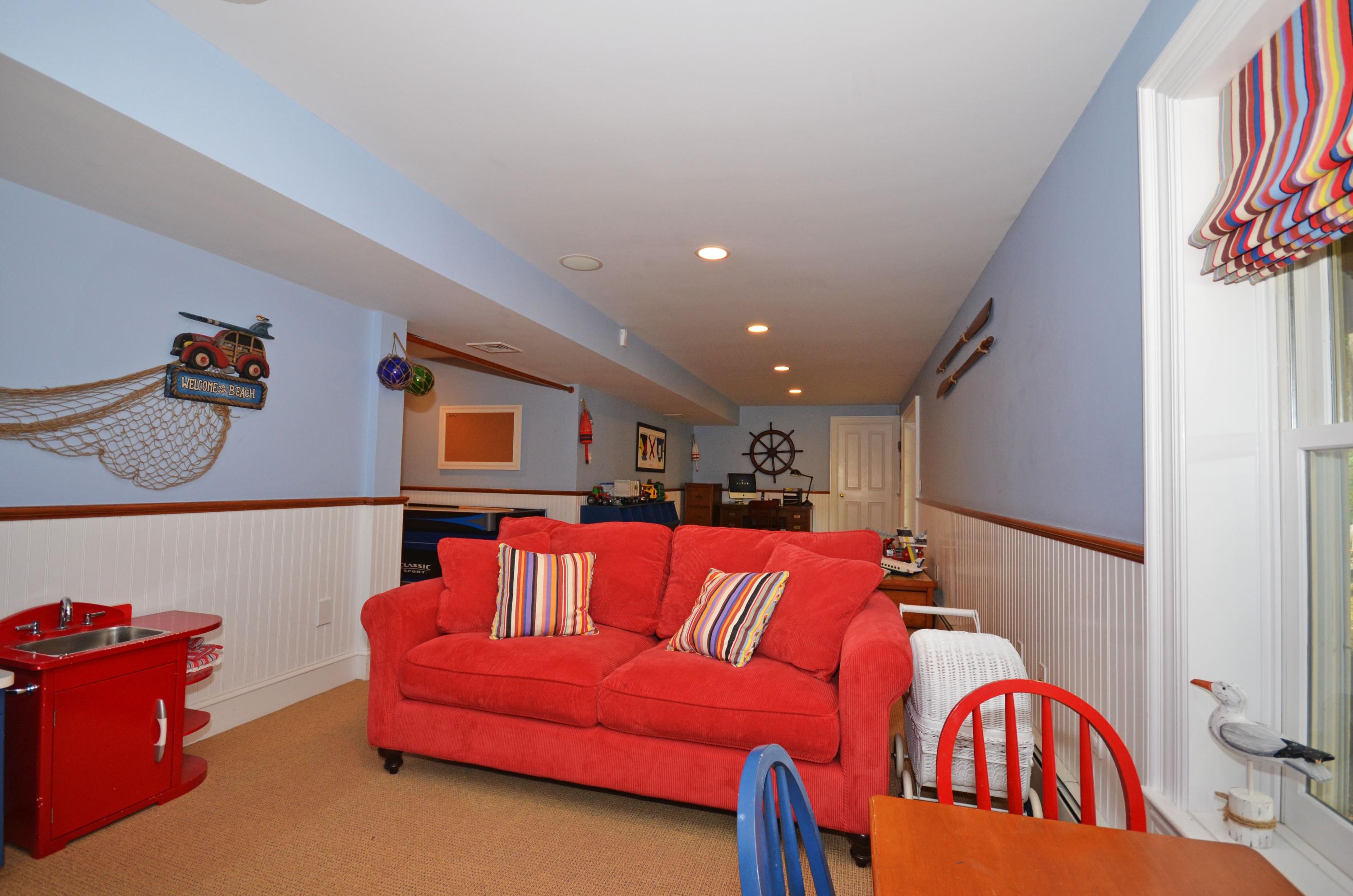 45 Brookside Road Darien, CT 06820 - Photo 21 of 24 a living room with blue lights with furniture