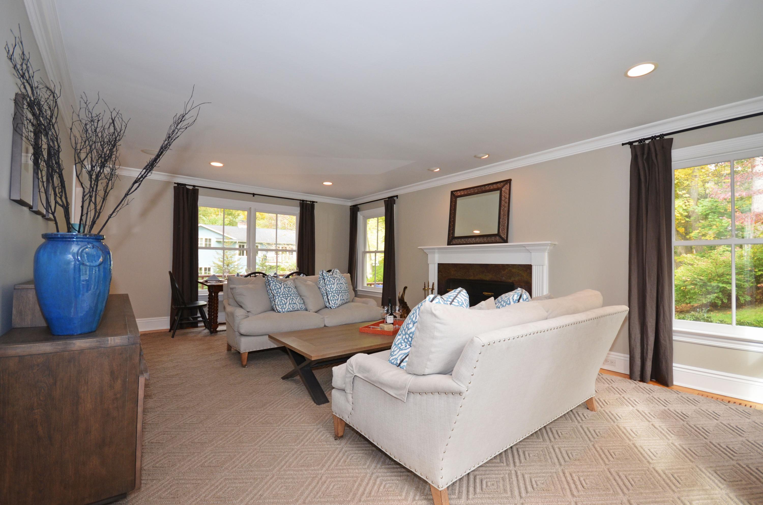 45 Brookside Road Darien, CT 06820 - Photo 5 of 24 a living room with furniture a large window and a fireplace