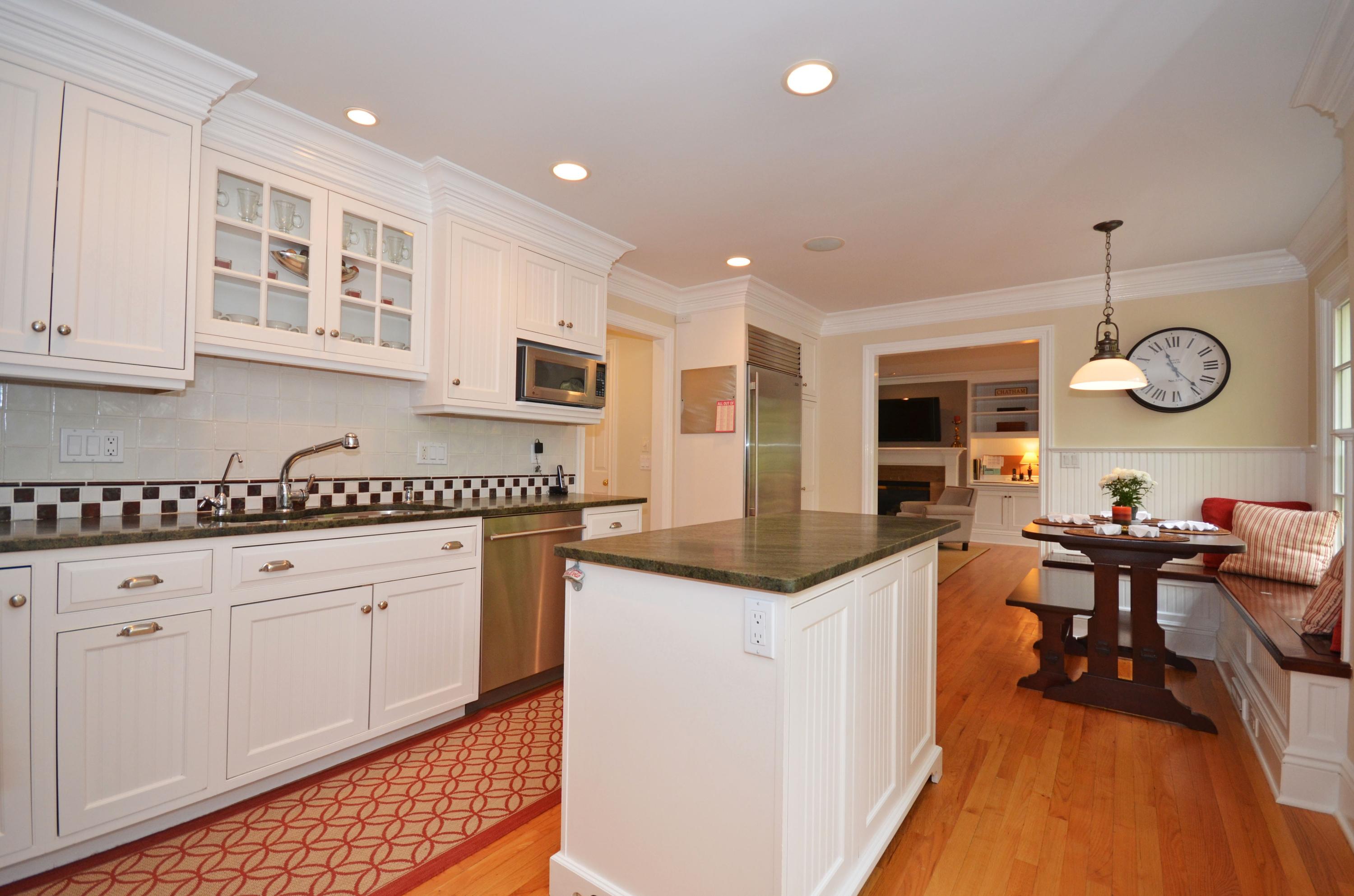 45 Brookside Road Darien, CT 06820 - Photo 7 of 24 an open kitchen with granite countertop a stove and white cabinets