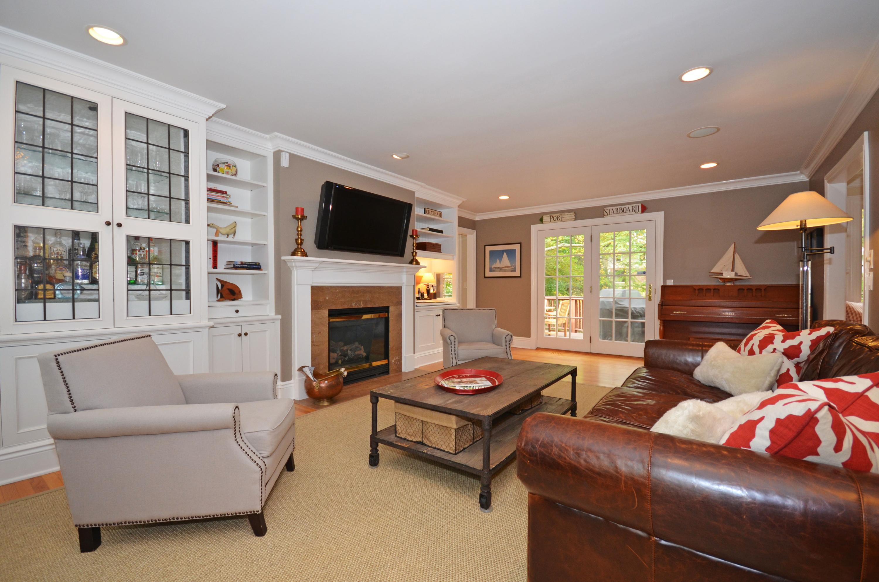 45 Brookside Road Darien, CT 06820 - Photo 10 of 24 a living room with furniture fireplace and a flat screen tv
