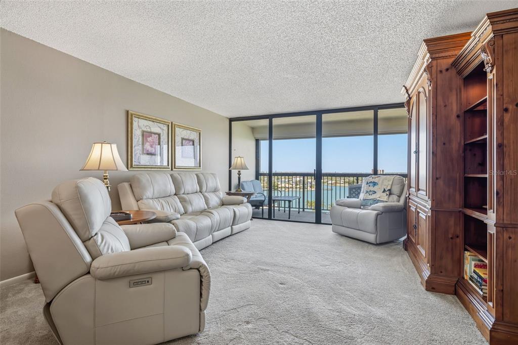 9425 Blind Pass Road, Unit 705 St. Pete Beach, FL 33706 - Photo 17 of 66 a living room with furniture and a large window