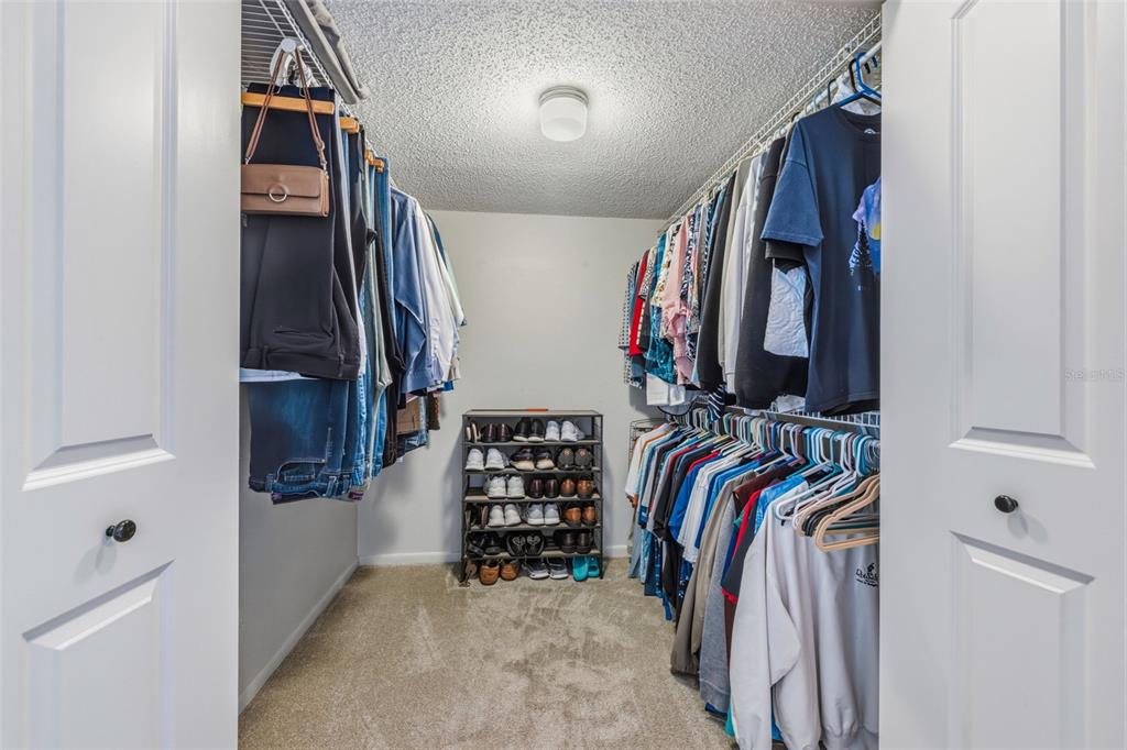 9425 Blind Pass Road, Unit 705 St. Pete Beach, FL 33706 - Photo 23 of 66 a view of walk in closet with clothes and shoes