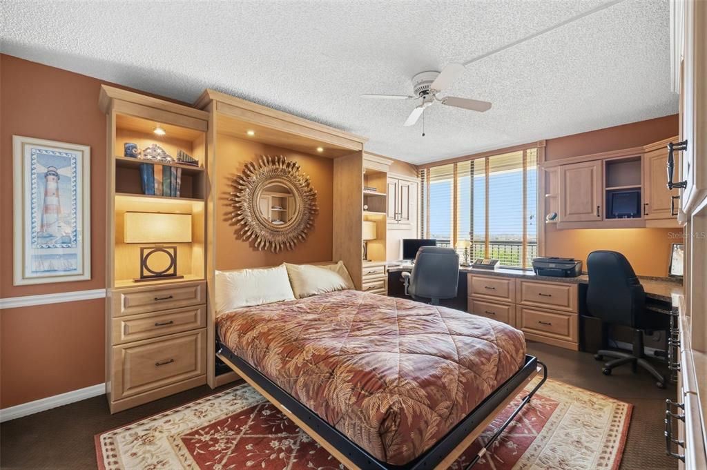 9425 Blind Pass Road, Unit 705 St. Pete Beach, FL 33706 - Photo 29 of 66 a bedroom with a bed and wooden floor