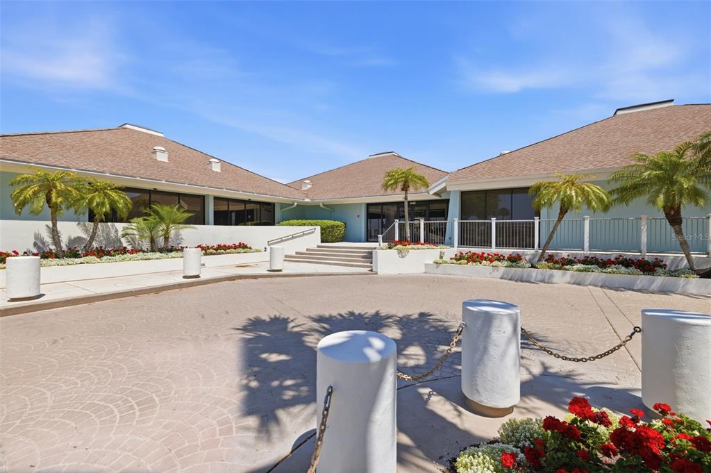 9425 Blind Pass Road, Unit 705 St. Pete Beach, FL 33706 - Photo 38 of 66 a swimming pool with outdoor seating and yard
