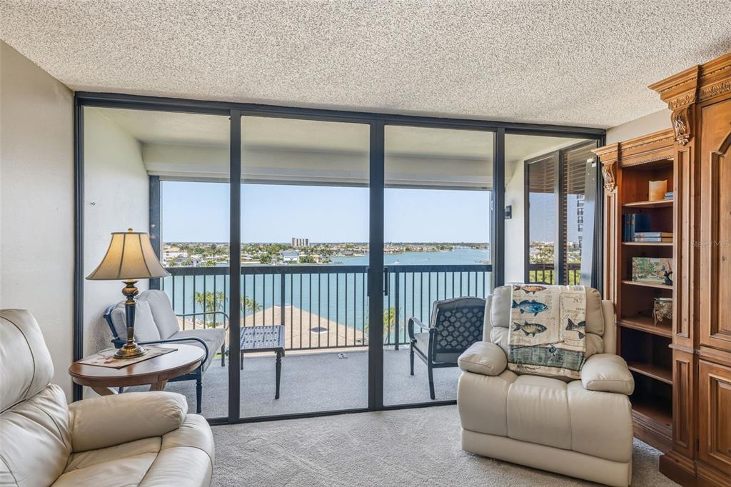 9425 Blind Pass Road, Unit 705 St. Pete Beach, FL 33706 - Photo 4 of 66 a living room with furniture and a large window