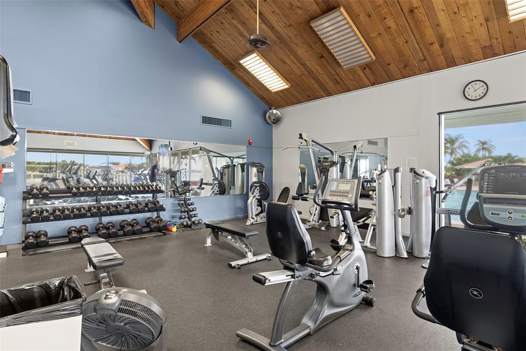9425 Blind Pass Road, Unit 705 St. Pete Beach, FL 33706 - Photo 41 of 66 a room with gym equipment and a large window