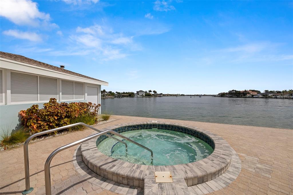 9425 Blind Pass Road, Unit 705 St. Pete Beach, FL 33706 - Photo 50 of 66 a view of a swimming pool with a lake view