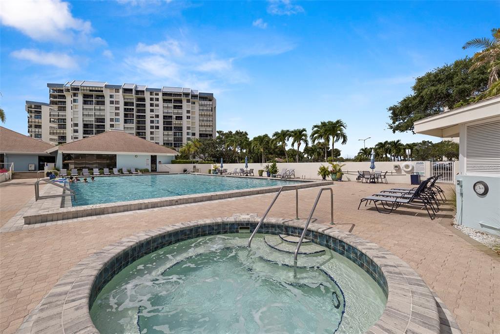 9425 Blind Pass Road, Unit 705 St. Pete Beach, FL 33706 - Photo 52 of 66 a terrace with outdoor seating and city view