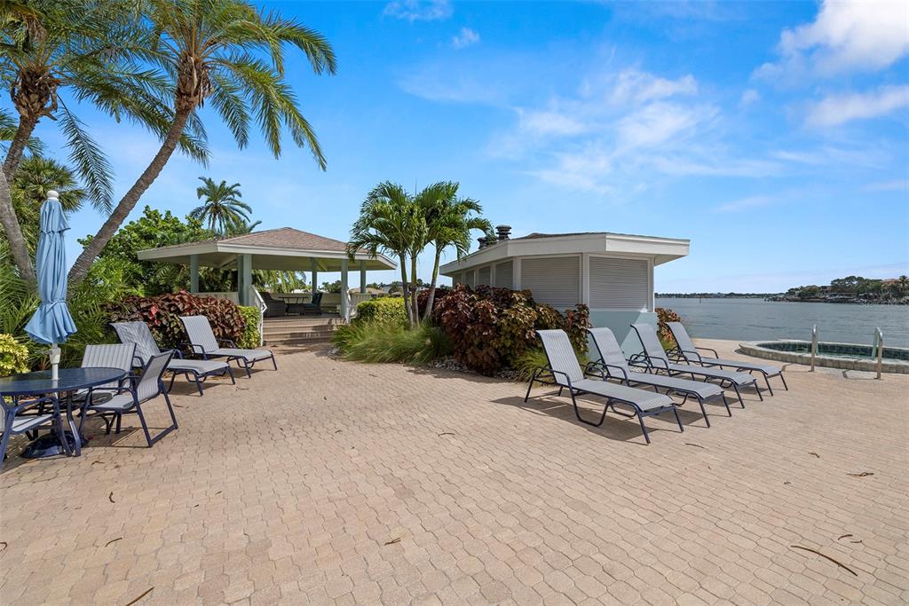 9425 Blind Pass Road, Unit 705 St. Pete Beach, FL 33706 - Photo 53 of 66 a view of a backyard with a sitting area and furniture