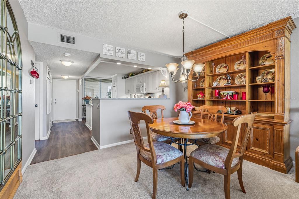 9425 Blind Pass Road, Unit 705 St. Pete Beach, FL 33706 - Photo 7 of 66 a view of a dining room with furniture