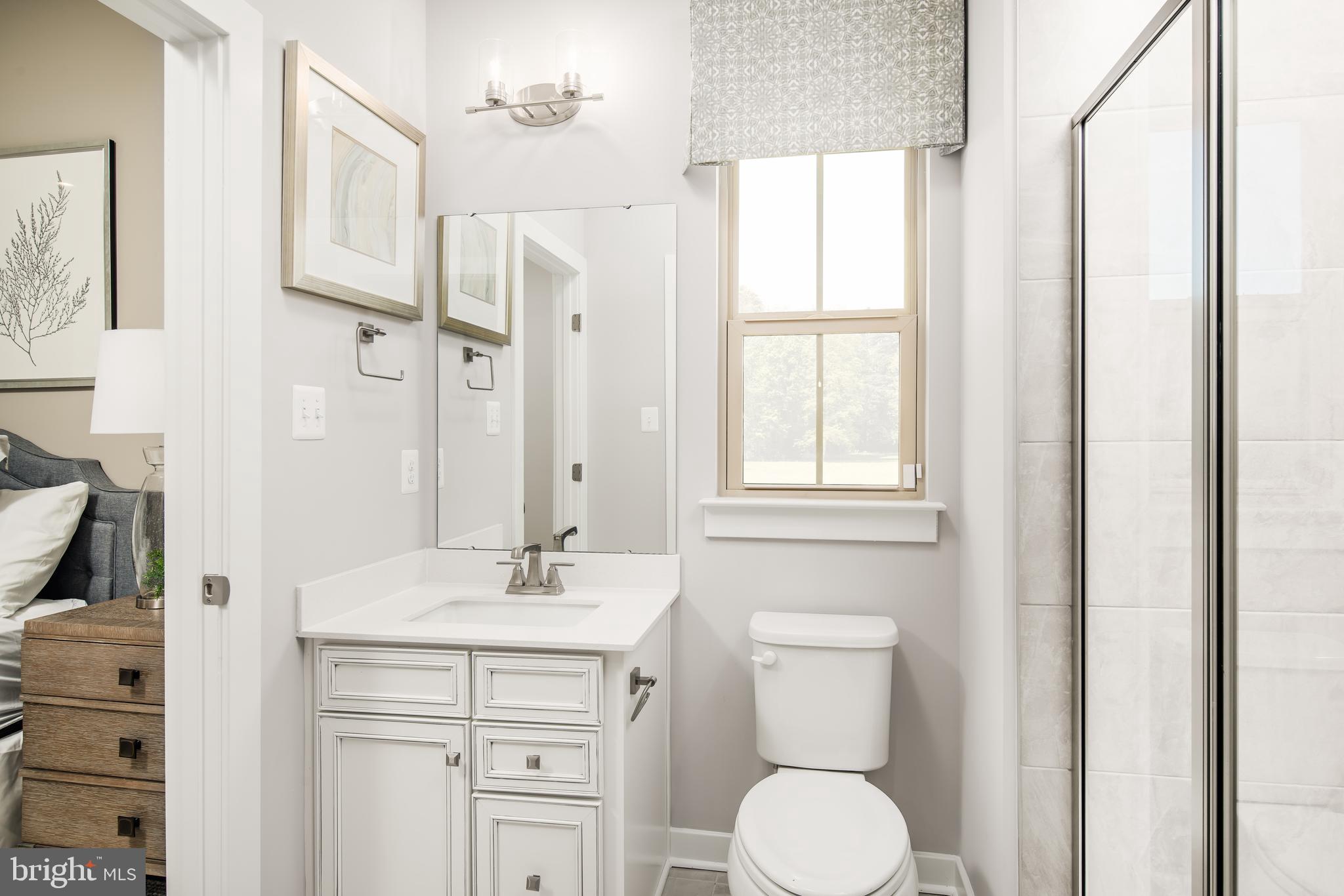 1415 Wallace Way Ranson, WV 25438 - Photo 8 of 15 a bathroom with a toilet sink and mirror