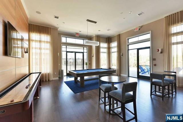 201 Dey Street, Unit 162 Harrison, NJ 07029 - Photo 14 of 21 a dining room with wooden floor and furniture