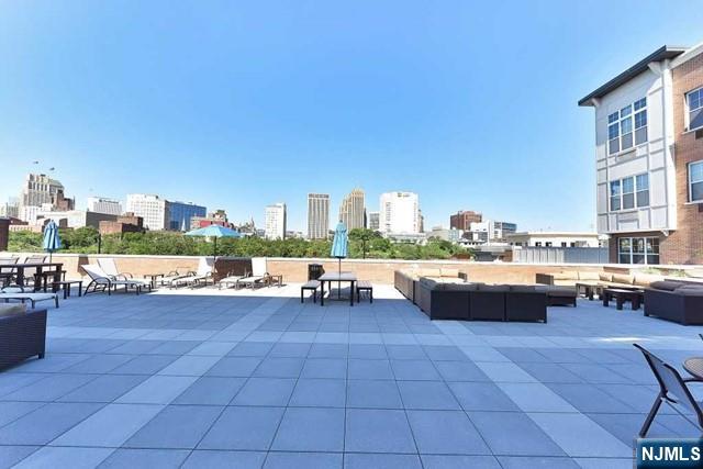 201 Dey Street, Unit 162 Harrison, NJ 07029 - Photo 16 of 21 a view of swimming pool outdoor seating and city view