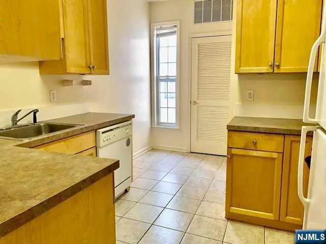 a kitchen with a sink and a refrigerator