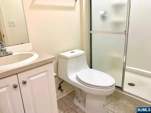a white toilet sitting next to a bathroom sink