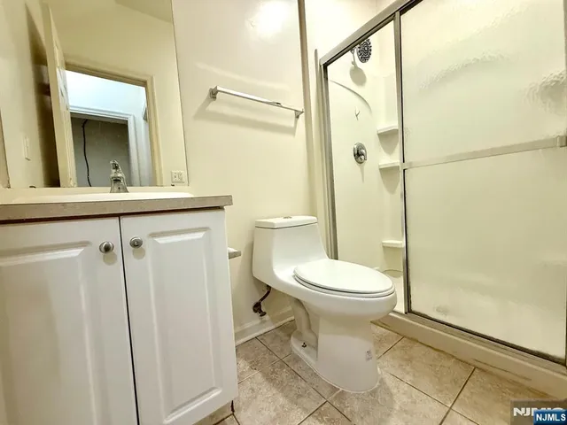 a bathroom with a toilet sink and shower